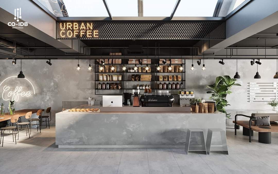 Quầy bar tiệm cà phê phong cách công nghiệp hiện đại, sử dụng chất liệu bê tông mài, kim loại sơn đen và hệ tủ trưng bày nổi bật bằng đèn rọi.