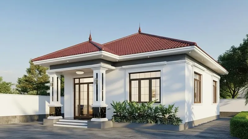 Mẫu nhà cấp 4 mái Nhật ngói đỏ, tường trắng phối phào chỉ xám, hệ hai cột vuông ốp đá đen ở chân và cửa kính khung gỗ.