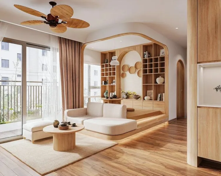 Mẫu phòng khách phong cách Japandi với nội thất gỗ tự nhiên, sofa bo cong, kệ trang trí âm tường và cửa kính lớn, mang đến không gian sống ấm cúng, tinh tế.