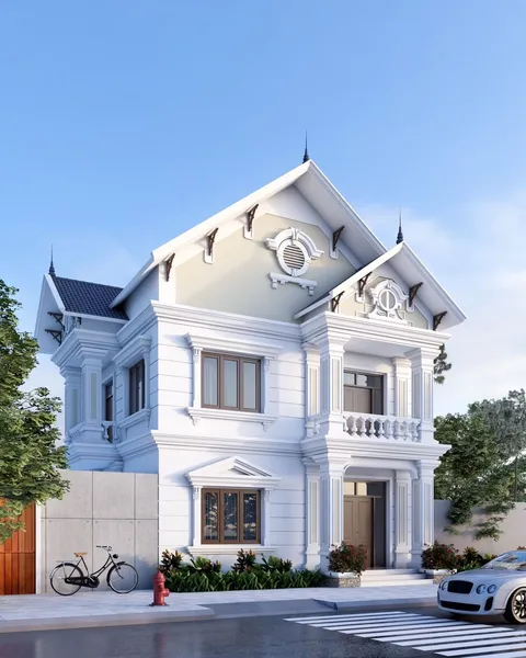 Mẫu biệt thự 2 tầng mái Thái diện tích 9x16m phong cách tân cổ điển màu trắng tinh khôi, mặt tiền hai gian bề thế có hệ phào chỉ tinh tế, cột vuông kiên cố và lan can con tiện truyền thống.