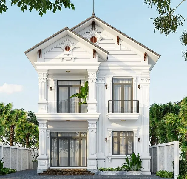 Mẫu biệt thự 2 tầng mái Thái tân cổ điển màu trắng tinh khôi, mặt tiền hai gian cân đối với hệ phào chỉ tinh xảo, cửa kính hiện đại và ban công sắt thanh lịch.