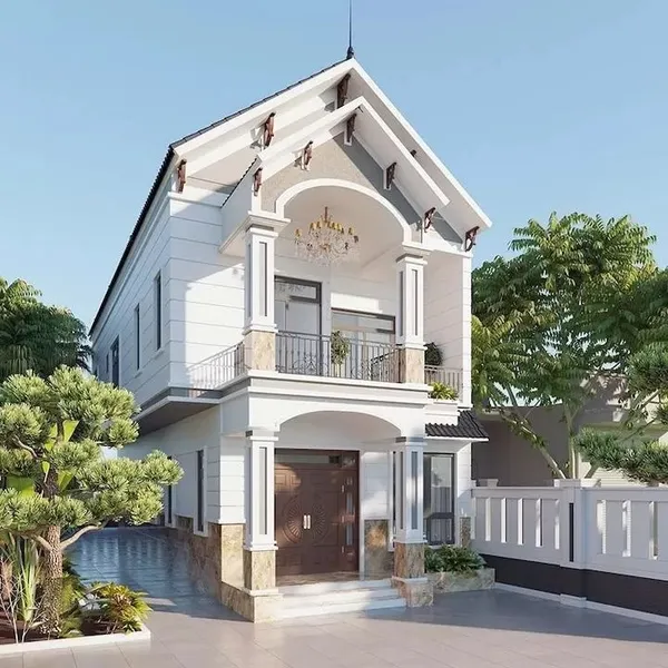 Mẫu nhà 2 tầng mái Thái nông thôn tân cổ điển sơn trắng, mặt tiền có sảnh vòm cong trang trí đèn chùm lộng lẫy, hệ cột vuông kiên cố và cửa gỗ sang trọng.