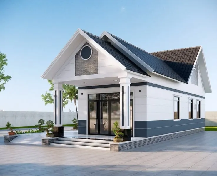 Mẫu nhà cấp 4 mái Thái hiện đại màu trắng phối xanh xám ghi, mặt tiền có sảnh hiên rộng thoáng, hệ cột vuông khỏe khoắn và cửa kính đen sang trọng.