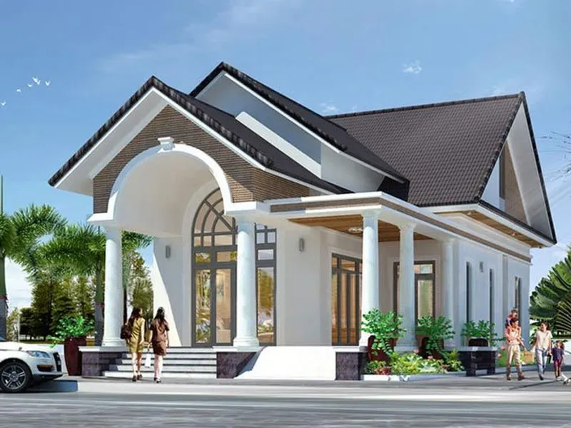 Mẫu nhà cấp 4 chữ L mái Thái mang phong cách tân cổ điển màu trắng kem, mặt tiền rộng rãi có sảnh đón vòm cong cao ráo và hệ cột tròn lộng lẫy.