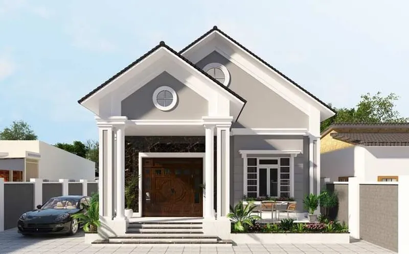 Mẫu nhà cấp 4 mái Thái hiện đại màu xám phối trắng, mặt tiền ốp đá đen vân mây sang trọng với cửa gỗ tự nhiên và sảnh hiên cao ráo.