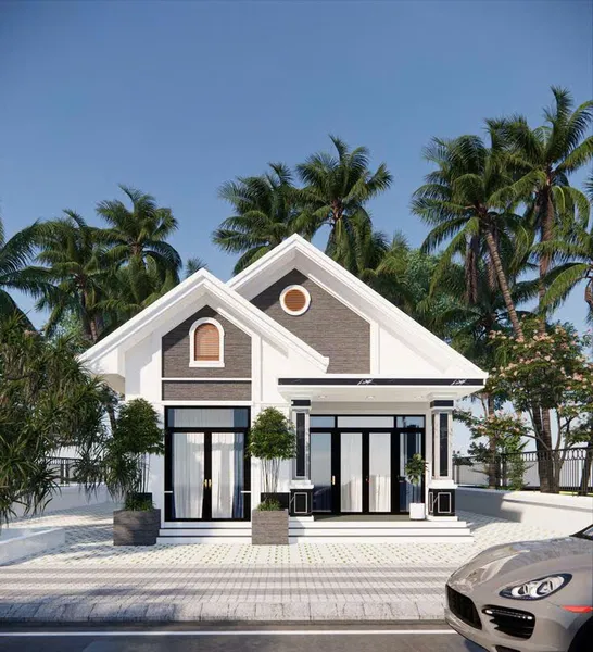 Mẫu nhà cấp 4 mái Thái hiện đại màu trắng phối xám đen, mặt tiền 2 gian rộng rãi với hệ cửa kính lớn và hàng cây cọ xanh mát xung quanh.
