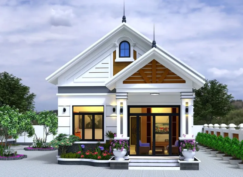 Mẫu nhà cấp 4 mái Thái hiện đại màu trắng phối chi tiết giả gỗ nâu, mặt tiền có sảnh hiên rộng trang trí hoa và hệ cửa kính khung đen.